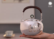 Load image into Gallery viewer, The work of Mr. Li Fuming, a national intangible cultural heritage inheritor, is "9999 pure silver, handmade, carved rabbit welcoming spring, pure silver teapot/Gong Dao Bei/kettle"