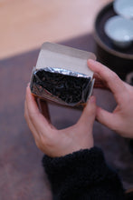 Load image into Gallery viewer, Treasured at Tongxinshe Teahouse: A Brew of 1998 Jiuqu Rou Gui Rock Tea