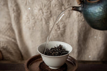 Load image into Gallery viewer, The 2022 Wuyi Rock Tea "Hu Xiao Yan Rou Gui" is made using traditional craftsmanship.