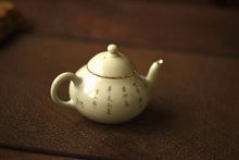 Load image into Gallery viewer, Pottery Meng Chen small teapot with silver mouth spout, elegant and playful, with smooth water flow and delicate hand-painted patterns.
